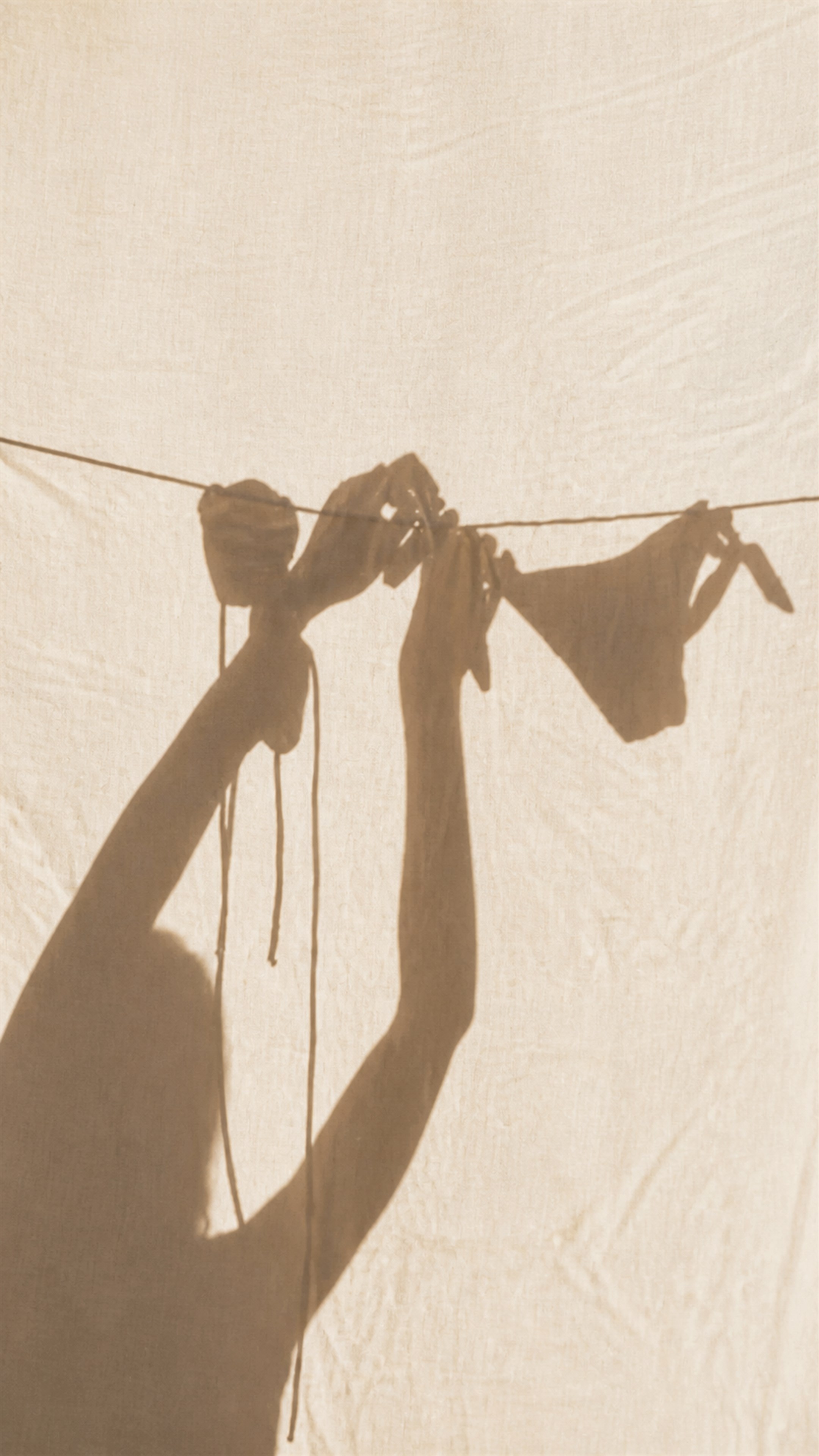 Shadow of swimsuits hanging on a clothesline