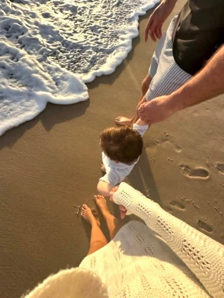 A mother and her toddler at the waterline